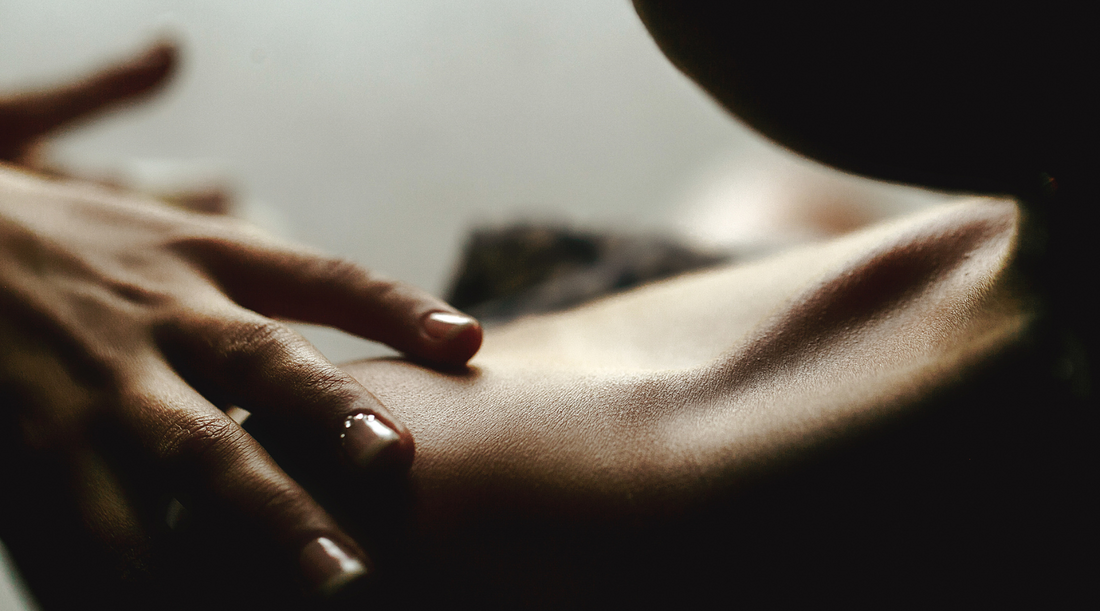 A hand touching skin. Skin barrier.