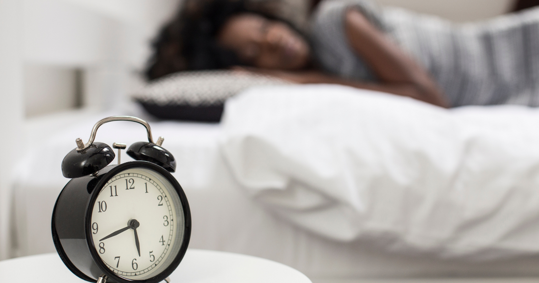 Morning alarm and sleeping woman