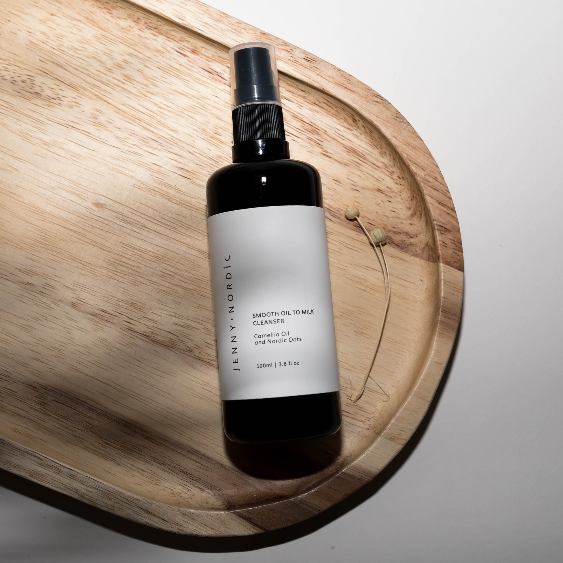 Smooth oil to milk cleanser on a wooden tray