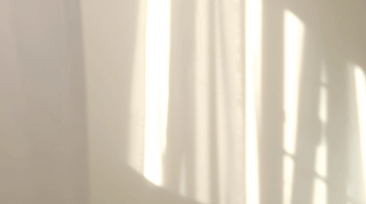 Morning sun reflections on white curtains