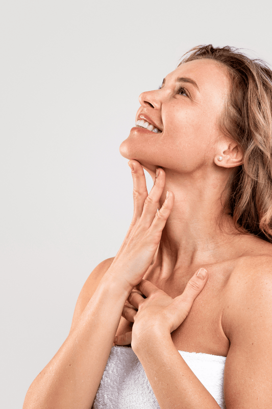 A women looking upwards while massaging her neck