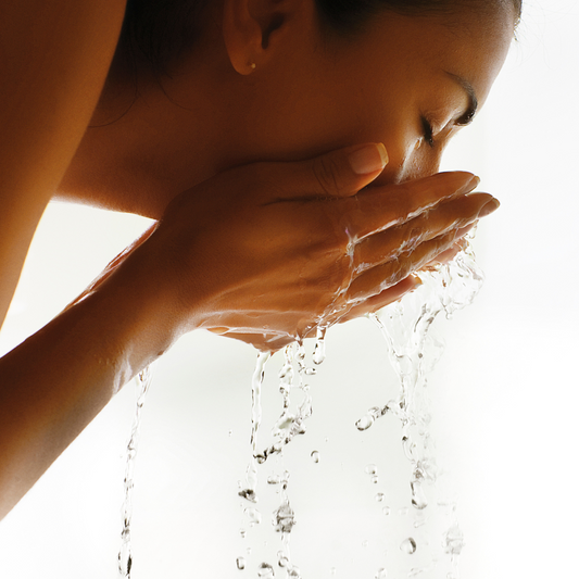 A woman rinsing her face with water