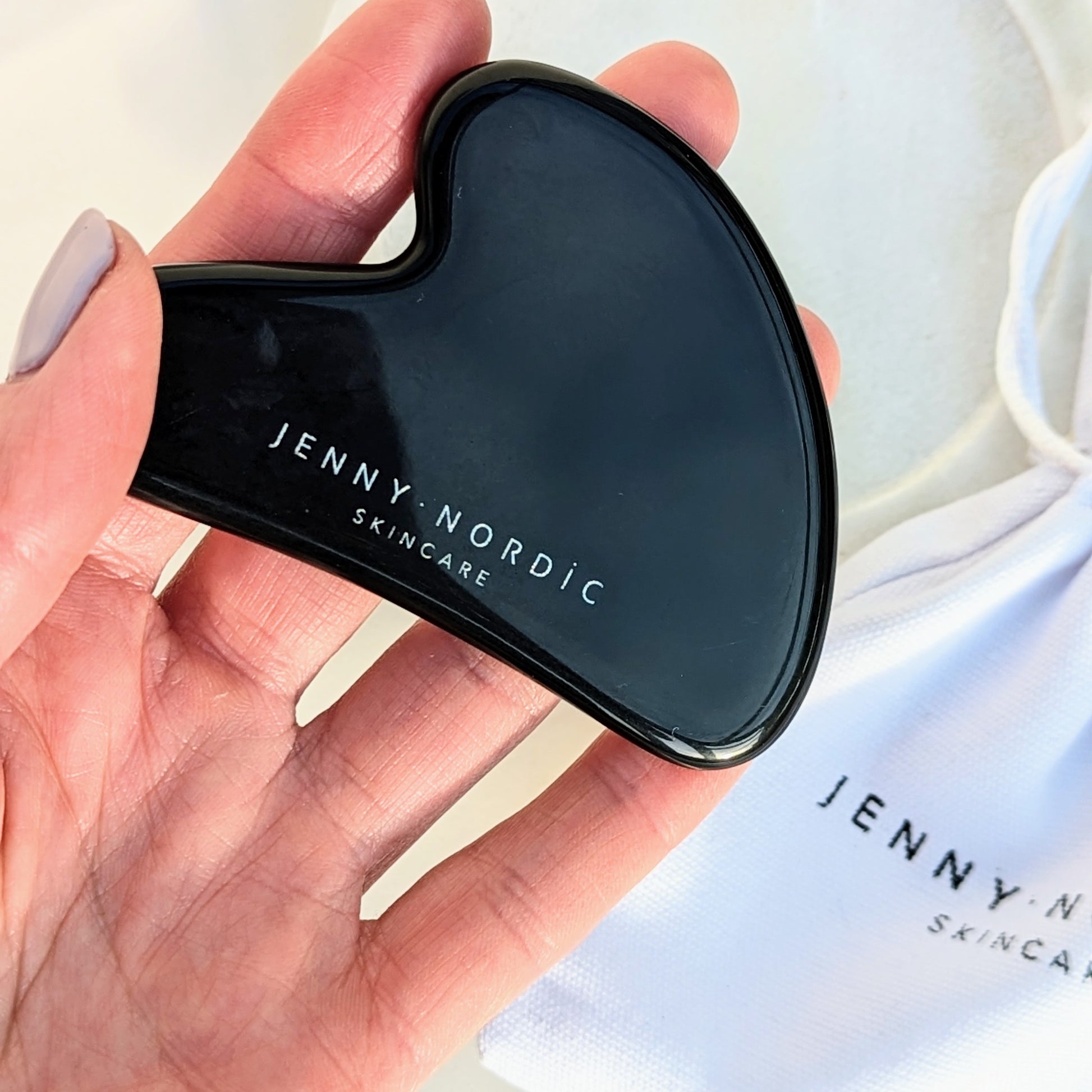 Jenny Nordic Skincare | Black obsidian gua sha tool in hand